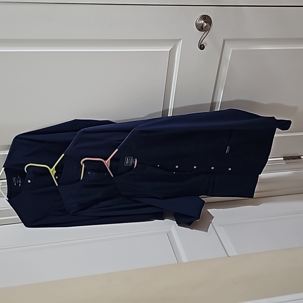 Three blue nursing scrub jackets